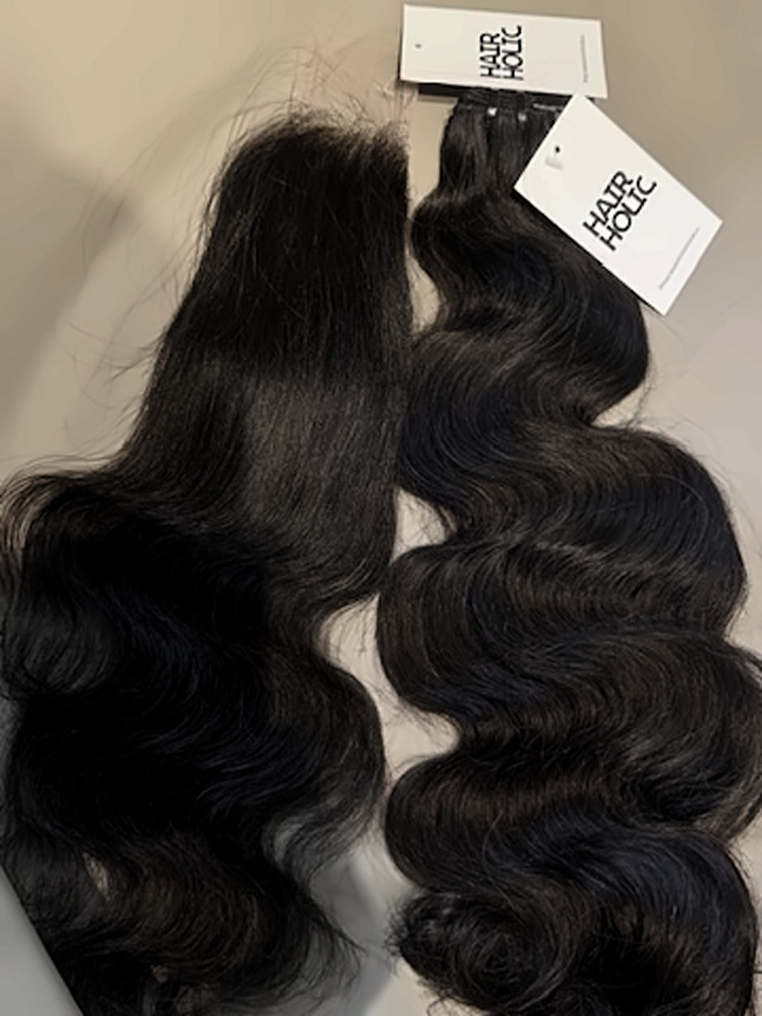 Vietnamese raw hair HD closure next to a matching bundle